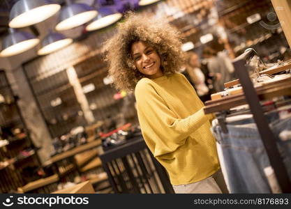 Pretty young black woman with curly hair in shopping