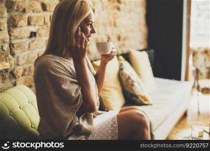 Pretty young blond woman sitting in the cafe