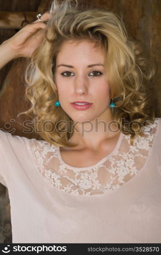 Pretty young blonde in a cream colored blouse