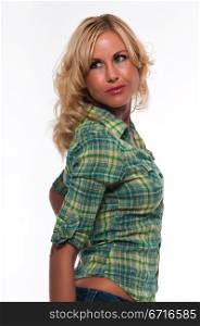 Pretty young blonde woman in a green plaid shirt and jeans