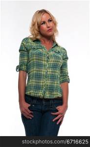 Pretty young blonde woman in a green plaid shirt and jeans
