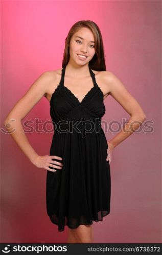 Pretty young brown haired teenage girl dressed in black