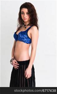 Pretty young brunette in a blue bra and black skirt