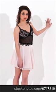 Pretty young brunette in a brown lace top and pink skirt