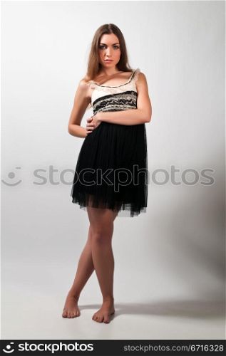 Pretty young brunette in a cream and black dress