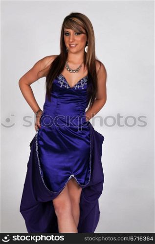Pretty young brunette in a long blue gown