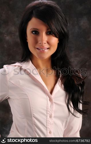 Pretty young brunette in a pink shirt