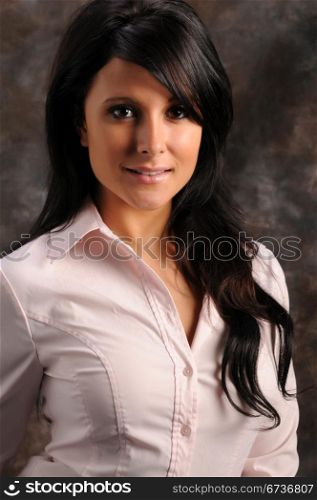 Pretty young brunette in a pink shirt