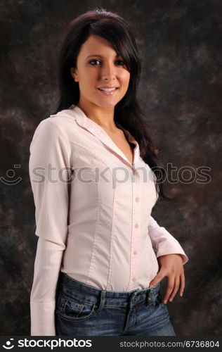 Pretty young brunette in a pink shirt and blue jeans