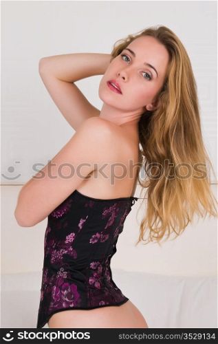 Pretty young brunette in a purple corset