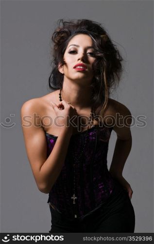 Pretty young brunette in a purple corset