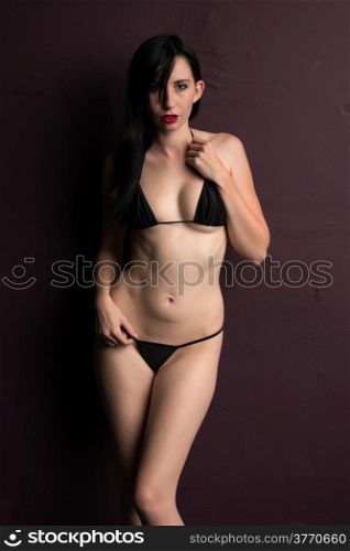 Pretty young brunette in a skimpy black bikini