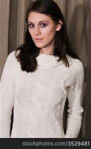 Pretty young brunette in a white knit sweater
