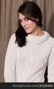Pretty young brunette in a white knit sweater