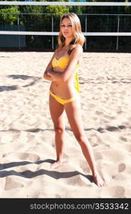 Pretty young brunette in a yellow bikini