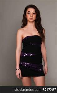 Pretty young brunette in an purple and black dress