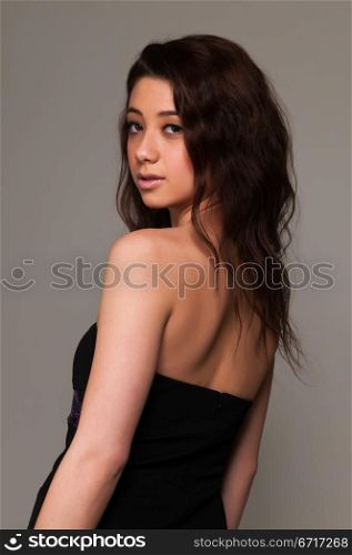 Pretty young brunette in an purple and black dress