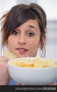 pretty young brunette woman eating chips