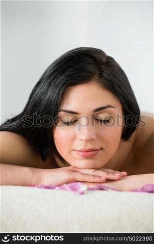 Pretty young brunette woman enjoying pampering that enhances her beauty