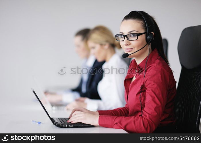 Pretty young business woman group with headphones smiling at you against white background