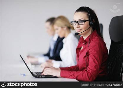 Pretty young business woman group with headphones smiling at you against white background