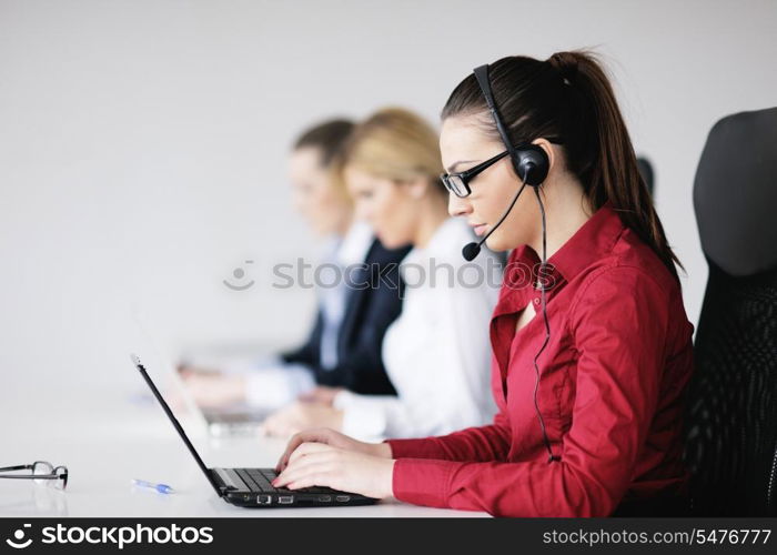 Pretty young business woman group with headphones smiling at you against white background