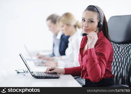 Pretty young business woman group with headphones smiling at you against white background