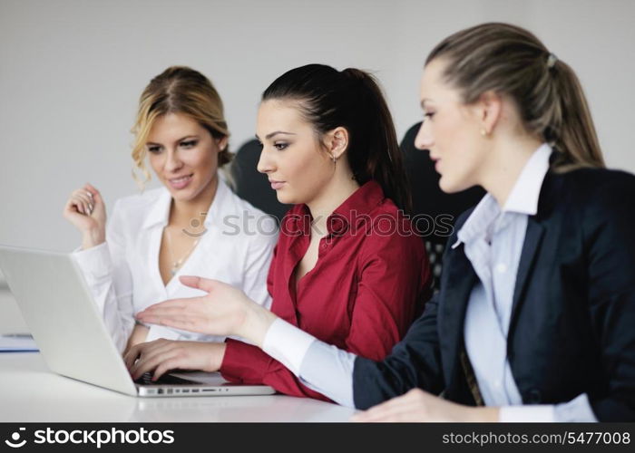 Pretty young business woman group with headphones smiling at you against white background