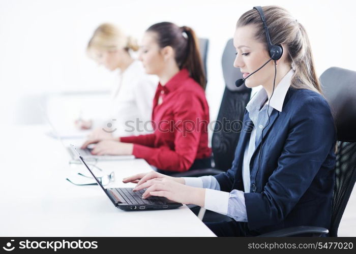 Pretty young business woman group with headphones smiling at you against white background