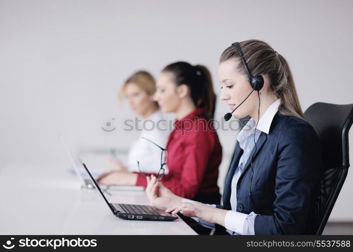 Pretty young business woman group with headphones smiling at you against white background