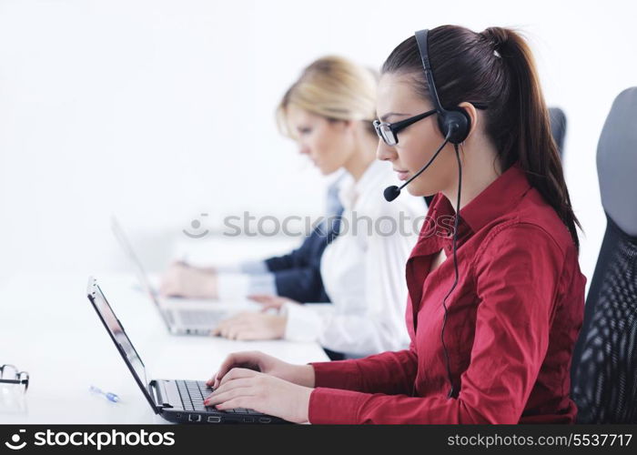 Pretty young business woman group with headphones smiling at you against white background