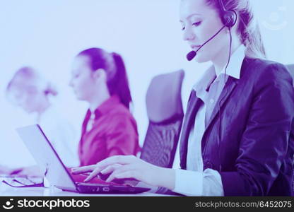 Pretty young business woman group with headphones smiling at you against white background