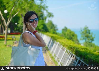 Pretty young business woman using mobile phone outdoor