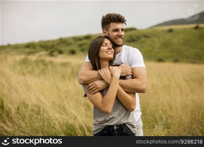 Pretty young couple in love outside in spring nature