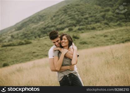 Pretty young couple in love outside in the spring nature