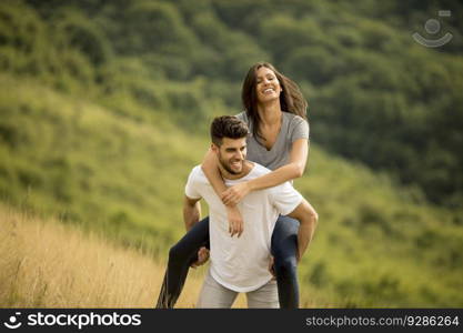 Pretty young couple in love outside in the spring nature