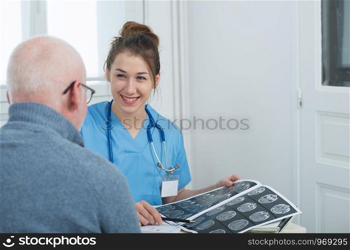 pretty young female doctor in the office with her patient