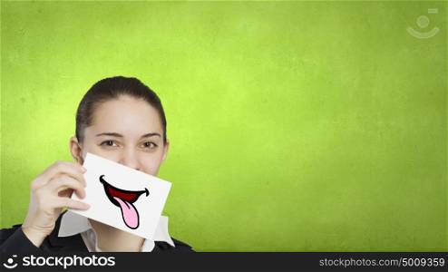 Pretty young girl holding white card with drawn smile. Your smile is your business card