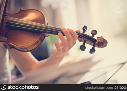 Pretty young girl practices on her violin, acoustic music