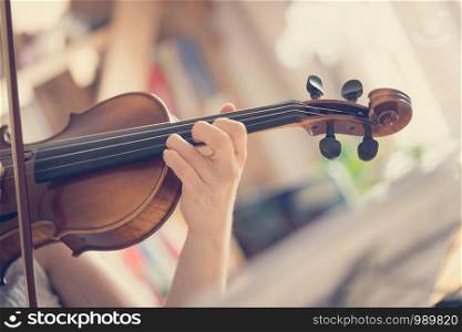 Pretty young girl practices on her violin, acoustic music