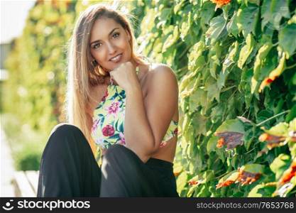Pretty young girl sitting on urban bench outdoors. Pretty young girl sitting on urban bench
