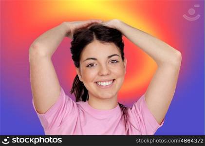 Pretty young girl touching her hair with a colored background