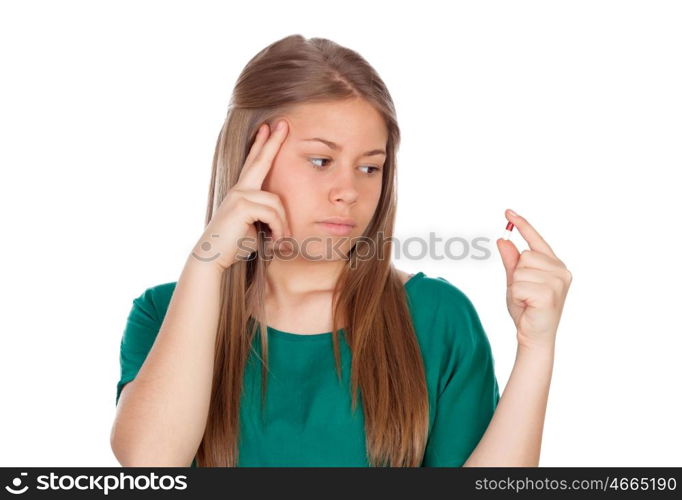 Pretty young girl with a pill isolated on white background