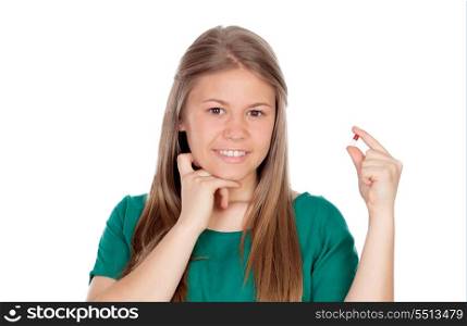 Pretty young girl with a pill isolated on white background