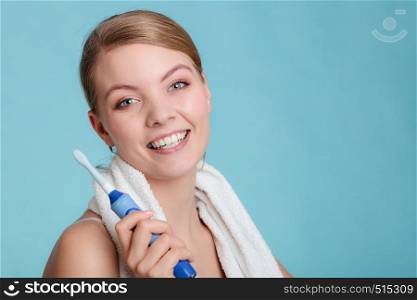 Pretty young girl with brush cleaning white using toothpaste. Happy woman cleaning her oral cavity caring about dental health holding toothbrush.. Young girl brushing oral cavity.