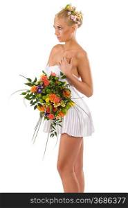 pretty young girl woth flowers and a bouquet in white short dress as spring season