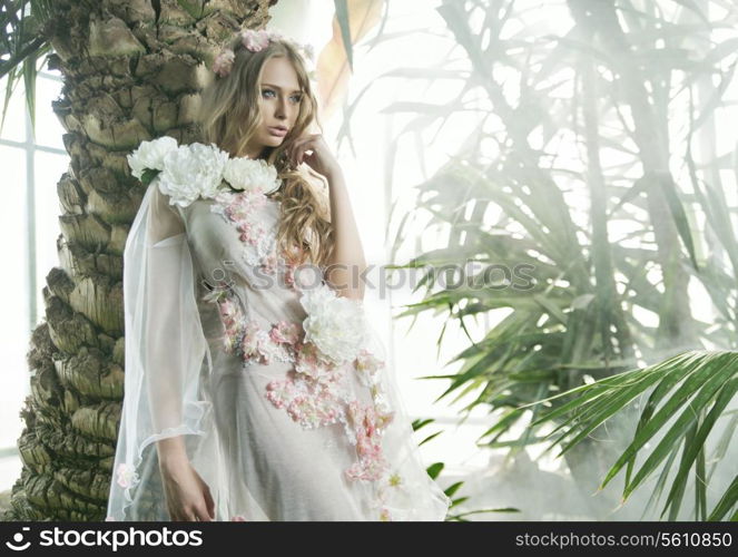 Pretty young lady in the green botanical garden