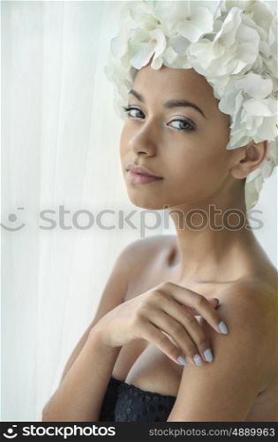 Pretty young lady with a white flower hat