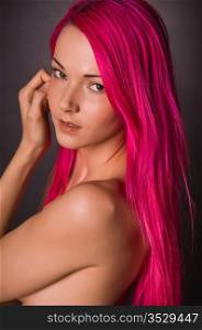 Pretty young nude woman with pink hair