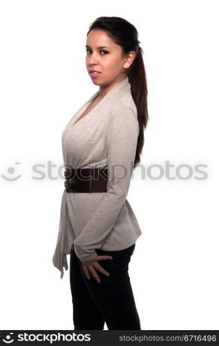 Pretty young petite Latina in a gray sweater and black jeans